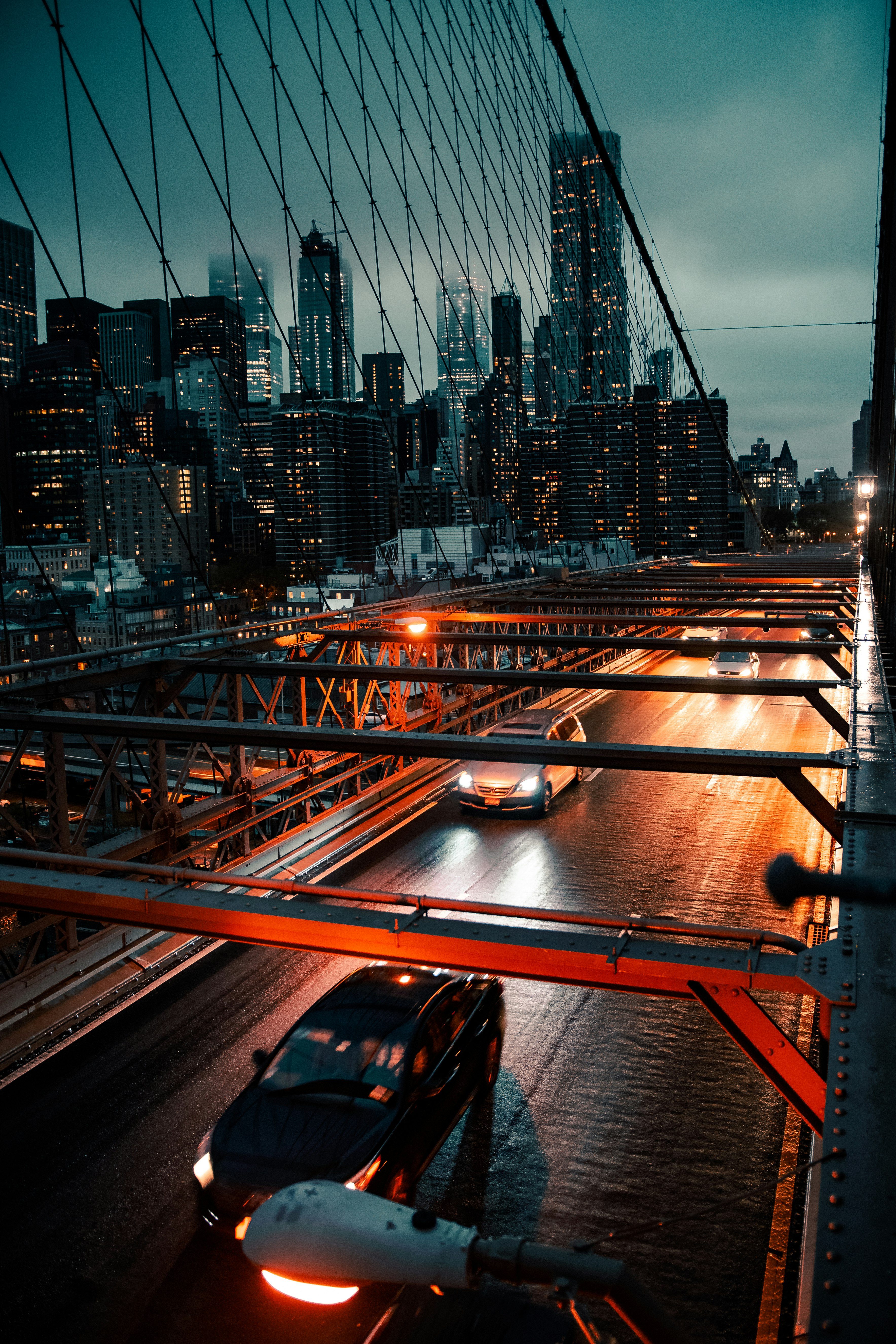 cars on road near city buildings during night time